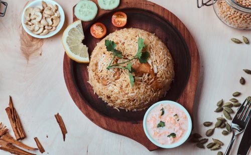 indian-traditional-dish-with-rice-cashew-nuts-sauce-lemon-vegetables-coriander-leaf-wooden-tray_613910-21742 indian-traditional-dish-with-rice-cashew-nuts-sauce-lemon-vegetables-coriander-leaf-wooden-tray_613910-21742